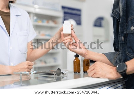 Close up hands of selling female pharmacist and male customer buying medicine in the pharmacy drugstore, hand over capsule pills of medicine from hand to another hand charge. Royalty-Free Stock Photo #2347288445