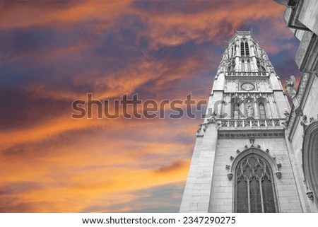 Great gothic church of Saint Germain l´Auxerrois (against the background of a sky at sunset), Paris, France