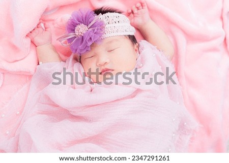 Newborn baby,Close-up beautiful sleeping baby boy. Newborn baby sleeping on a blanket, beautiful pictures, seven days, newborn baby wearing large cloth, cloth rose headband