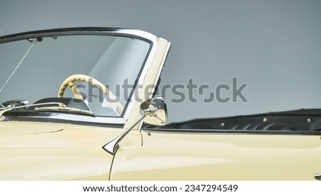 Chrome side mirror on a convertible car