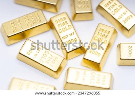 A lot of simulated gold bricks are on the table.Gold bricks representing wealth economic investment Royalty-Free Stock Photo #2347296055