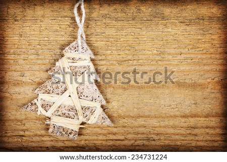 One Christmas baubles in shape of Christmas tree on wooden background   