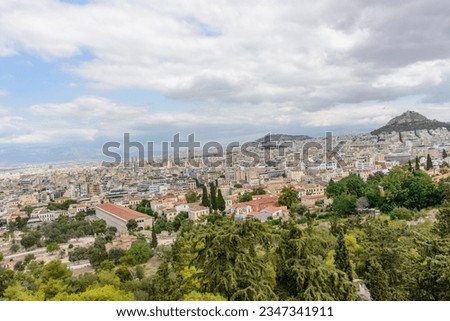 The city of Athens under a cloudy sky 