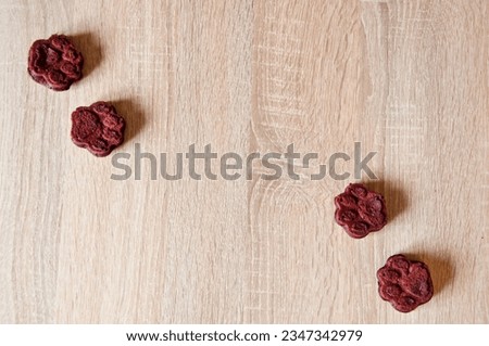 homemade dog biscuit. paw bakery cookie. pet cake. dog treat. pastry food for cat. appetizing dog muffins on wooden background. dog birthday. red velvet. paw shaped pet treat. banner advertisement. Royalty-Free Stock Photo #2347342979