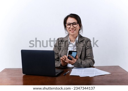 Happy and smiling Asian business woman sit work at office using phone isolated on white background