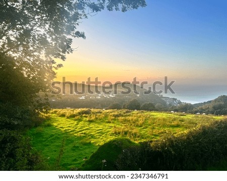 Summer sunset overlooking the valley in Lynmouth, North Devon UK Royalty-Free Stock Photo #2347346791
