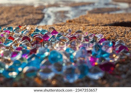 Colorful diamonds on the beach.
Each diamond caught the glimmer of the sun, glistening in the sand.
The sparkles of the diamonds lit up the shoreline, creating a mesmerizing landscape.
