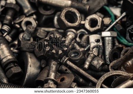 Background with bolts, screws and other repair parts in close-up. Metal parts for various repairs. Macro of recycled metal bolts. High quality photo
