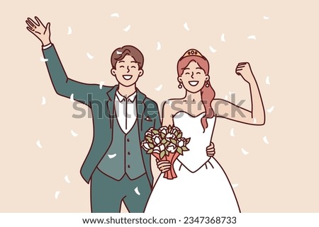 Wedding bride and groom with bouquet waving hand during festive marriage ceremony. Happy man and woman are proud of creation of new family and greet relatives or friends attended wedding celebration Royalty-Free Stock Photo #2347368733