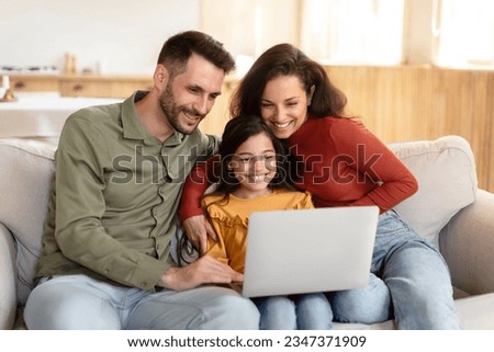 Online Offer. Cheerful Parents And Daughter Using Laptop, Websurfing And Typing, Family Spending Time Together With Computer, Visiting Internet Website At Home, Sitting On Sofa Indoor