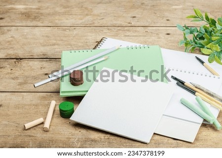 Back to school concept. Office eco friendly supplies, recycling materials, zero waste technologies. Wooden boards background, flat lay, copy space