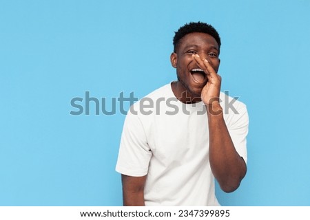 african american man shouting and saying message on blue isolated background, guy announcing secret and whispering on copy space Royalty-Free Stock Photo #2347399895