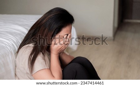 Sad depressed asia woman suffering on the white bed, she is sitting in bed and touching her forehead, sleep disorder and stress concept Royalty-Free Stock Photo #2347414461