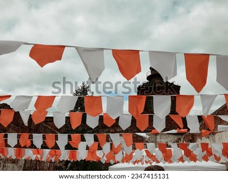 flags garland decorations for holiday festival, white red, fluttering in the wind, street festival in the afternoon, concept holidays outdoors