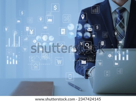Businessman and icon operating a laptop