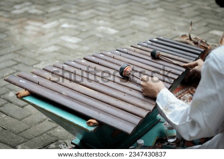 A photo of people playing angklung at the Indonesian Cultural Festival that can be used for various needs, taken in Bekasi City, Indonesia on March 23, 2022