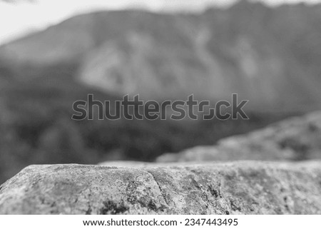 Stone table on the background of mountains. Black and white toned image 