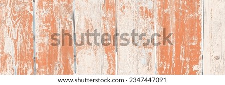 Picket fence with peeling paint. Wood texture. Old rough and cracked planks. Close-up. Perfect for background and design.