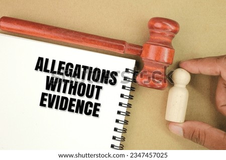 judge's hammer and white paper with a patch of allegations without evidence. the concept of accusations without basic evidence Royalty-Free Stock Photo #2347457025