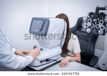 Woman optical shop happy customer doing eyesight measurement with optical phoropter check eye distance for eyeglasses is optical eye shop service. Royalty-Free Stock Photo #2347457785