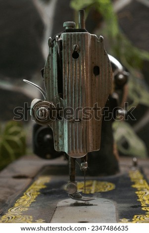 old sewing machine on stonewall background