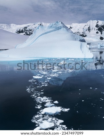 Berg bits; Antarctic Peninsula; Brash ice lane; Edge of brash ice; Sculpted berg, brushed ice; Ship's wake, through brash ice; Sunset clouds, over brash iced; Antarctic Peninsula; Blue Bay
