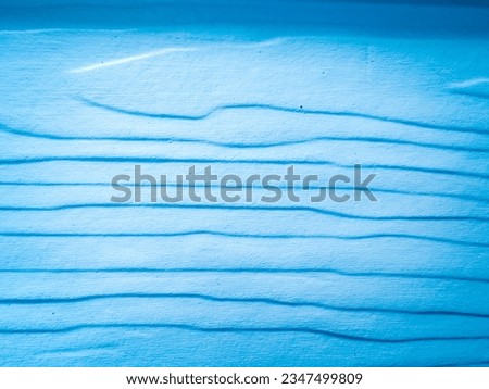 The texture of the wood grain is painted in light blue.