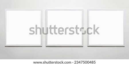 white picture frames on wall. Stylish modern square photoframes for poster or picture. template for presentation your photo art or other crafts