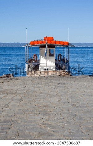 Small Greek passenger boat attached to the dock
