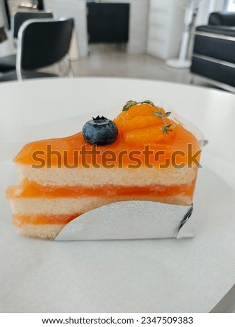 orange cake on white dish in cafe holiday 