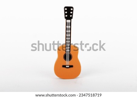Plastic mini guitar toy isolated on white background