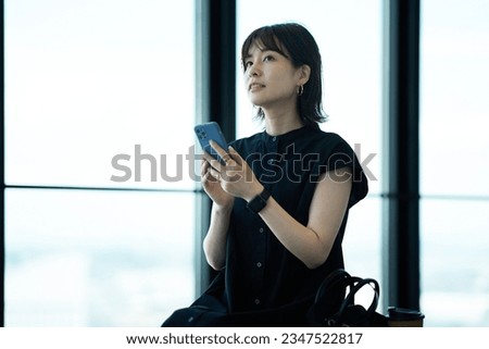 young woman holding a smartphone