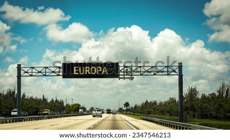 picture shows a signpost and a sign pointing towards Europe in German.