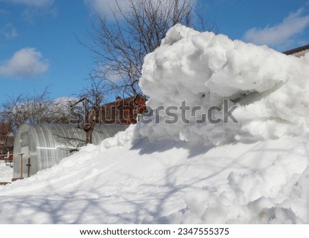 Vaskelovo,  Leningrad region, Russia, 03-24-2019: melted snowdrift, similar to Hokusai Wave's engraving, on a sunny day