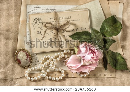 old letters, postcards and vintage things. nostalgic paper background with dry rose flower