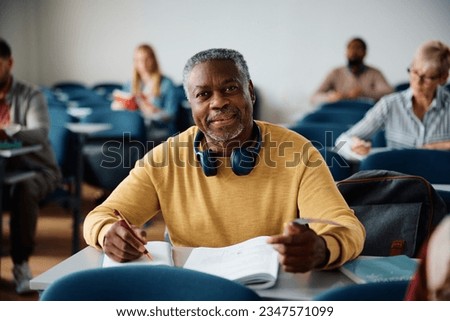 African American mature student learning during adult education course and looking at camera. Royalty-Free Stock Photo #2347571099