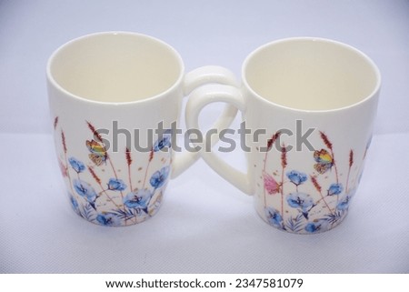 Mock up- design set of elegant and traditional teapot colorful butterfly  and blue flowers on white coffee cup and Tea cup on cup's plate beside the hot tea pot , design drink-ware isolated.