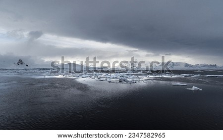 A break in the clouds, above sea ice; Cuiverville, Island, Antarctic Peninsula