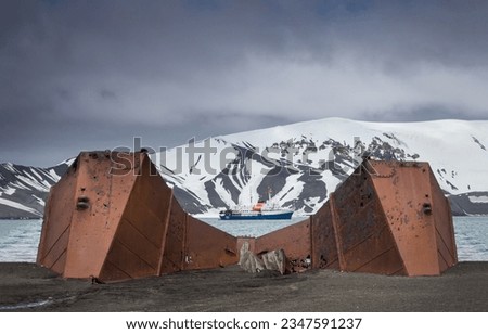 Abandoned dry dock, partly submerged, by mud flow; Deception Island, South Shetlands Royalty-Free Stock Photo #2347591237