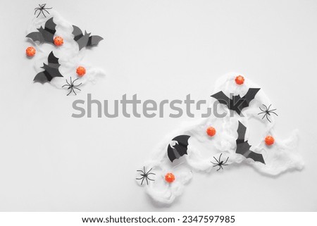 Composition with pumpkins, web, paper bats and spiders on white background. Halloween celebration concept