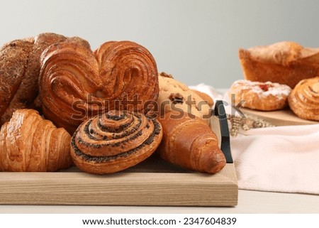 Different tasty freshly baked pastries on white table