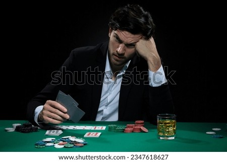Caucasian Young Handsome Pocker Player Staking and Betting To Win At Pocker Table With Chips And Cards. Horizontal Image Royalty-Free Stock Photo #2347618627