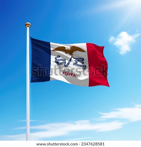 Waving flag of Iowa is a state of United States on flagpole with sky background. Royalty-Free Stock Photo #2347628581