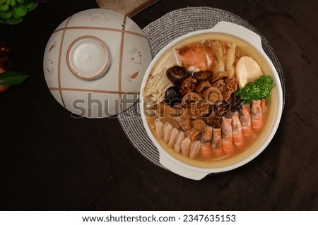 braised premium seafood in clay pot traditional chinese new year Peng cai with big prawn, herbal, abalone, meat, oyster, mushroom, scallop in gravy sauce soup for restaurant banquet halal food menu Royalty-Free Stock Photo #2347635153