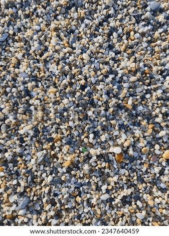 Small colored round pebbles on the beach