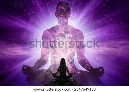 Woman doing yoga in front of giant human silhouette with universe Royalty-Free Stock Photo #2347649183
