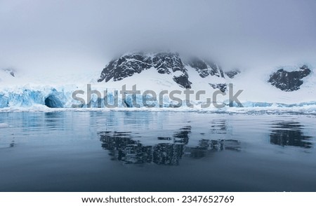 Early morning clouds, over mountains; Floating berg, mountains, low clouds; Glacier cave; Golden iceberg; Antarctica, Antarctic, Blue Peninsula; High-key light, at dawn; Antarctica Bay