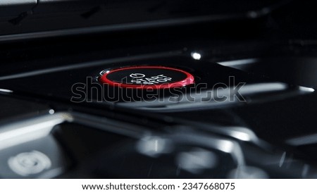 Detailed close up of a engine starting button surrounded by carbon fibre Royalty-Free Stock Photo #2347668075