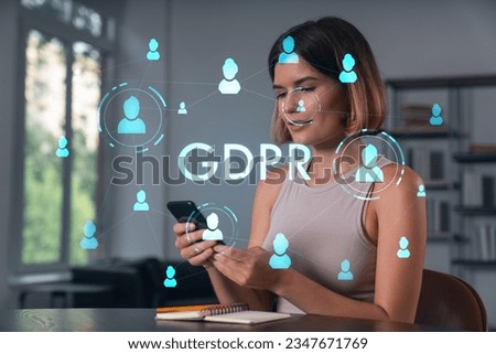 Smiling businesswoman in casual wear holding using smartphone typing at office workplace with notebook. Concept of distant work, business education. Data security hologram