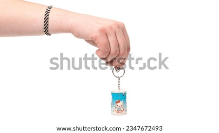 Woman hand holds key ring isolated on a white background. High quality photo